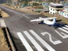 Notice the runway's downward slope as this airplane gears up to take off from Lukla