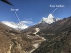 Just barely peeking out from the clouds, I glimpsed Everest and Ama Dablam from one of my helicopter rides! For reference, the black line at the top is the helicopter's rotor blade  
