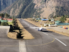 A plane taking off from Lukla down the short, declined runway