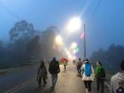 Passing through the fog at dawn, surrounded by lights and other travelers
