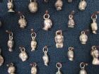 Little silver trinkets in different shapes, each one symbolizing a prayer that the Virgin of Angels answered