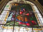 A beautiful stained-glass window in the Basilica, picturing the indigenous woman finding the little black Virgin of Angels in the forest