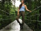 Standing on a bridge over a river in the forest, enamored by the beauty of Costa Rica