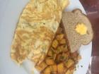 A vegetable omelette with potatoes and toast 