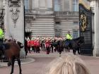 This shows the opened gates and members of the Metropolitan Police on horseback watching the crowds 