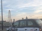 A London cab, driving along the River Thames in central London
