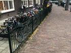 A row of children's bikes parked outside a school