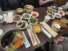 Eating 비빔밥 (bibimbap), a traditional Korean food, with friends