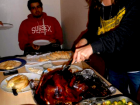 Abby carving the turkey for her Thanksgiving celebration with friends 