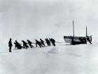 Members of the Trans-Antarctic Expedition 1914-1916 pulling one of their smaller boats named James Caird