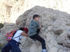 Orit and her middle child climbing the rocks at Ein Gedi