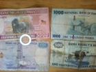 Rwandan francs (5000, 2000, 1000, 500, and a 100 RWF coin)