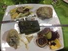 A close up of the Christmas dinner - a meatloaf, chicken, vegetables, a tamale in the middle