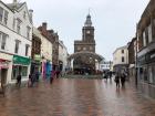 The High Street in Dumfries with people walking around to shop