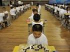 A lot of kids play complicated games like this one called "Weiqi," or "Go" 