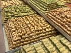 Stacks of baklava and other traditional Arabic desserts on display at a bakery
