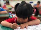 A first grader focusing on the alphabet