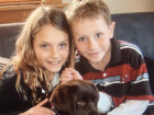 Kate and her brother pose with their dog, Coco
