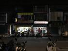 Scooters parked outside of stores at night