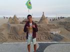 In front of a giant sandcastle welcoming tourists to Rio for the Olympics in 2016