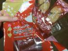 This is a container of sweets that has an outer wrapping of plastic, a plastic mold with places for two sweets each, and each sweet is individually packaged in plastic