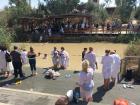 Many different kinds of Christians from all over the world getting baptized in the Jordan River