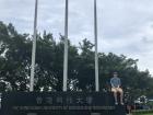 Me sitting on the welcome sign at my university abroad