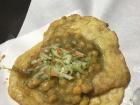 Doubles is a very common Trini street food. It’s bara (a fried flat bread) stuffed with channa (curried chick peas, spices, and tamarind). It is commonly eaten during Diwali