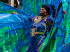 A woman in a costume playing mas on Carnival Tuesday during the festival. (Wikimedia Commons)