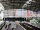 High speed train station in Shanghai. You can see a green train pulling up to the right and one is parked on the left.