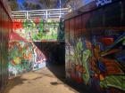 There is a lot of colorful graffiti around the train stations.