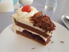 A slice of Black Forest cake includes chocolate cake, cream, chocolate and cherry compote