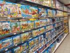 Sets of Playmobil toys lining the shelves of a department store