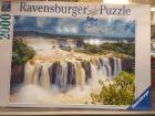 The cover of a jigsaw puzzle box depicting a raging waterfall