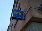 A blue sign with yellow lettering advertising a chain store with a wide selection of cheap goods