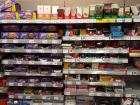Various types and flavors of chocolate lining the shelves of a supermarket aisle