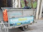 Portable garbage cart with encouraging sign 