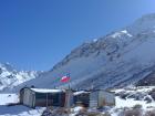 Santiago is very close to the Andes mountains: can you spot an animal in the left-hand corner of this picture? And what does the flag represent? 
