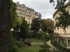 Parisian buildings overlooking a garden.