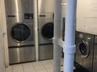 This is the entrance of a restaurant, which is built to look like a laundry mat.