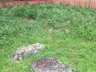 An broken obelisk in a ruined Roman villa by the lake