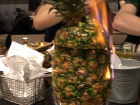 A pineapple on fire with pork inside 