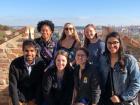 The Fulbrighters taking a group picture with the view of Prague in the background