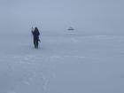 Sea ice scientist Aly Stocker followed behind the sled, measuring snow thickness with a special probe