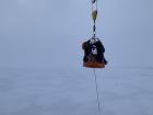 Getting from the ship to the ice is half the fun; We stand on a basket that is lifted and lowered by one of the ship's cranes