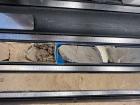 Can you see where this core sample changes from hard ocean crust to the sediments that were deposited on top of it over the years?