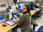 Alina, a sedimentologist, looks at tiny shells made by one-celled organisms through this microscope