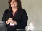 Giving a talk about my work in the U.K. with US-RSE's unicorn mascot