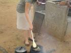 Helping with a Peace Corps cooking competition in South Africa, using a traditional "potje" cooking pot similar to those used in Namibia