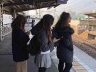 People on the platform line up behind the line that signals the train door